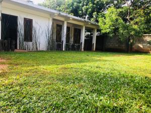 a house with a yard in front of it at Nature Rock Dambulla in Dambulla