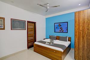 una camera con letto e parete blu di Collection O Daffodils a Gurgaon Altre 24 foto