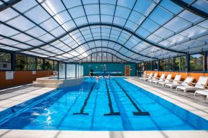 a large swimming pool with a glass ceiling at Tasman Holiday Parks - Merimbula in Merimbula
