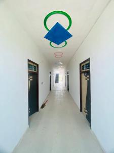 an empty hallway in an office building with a blue star on the ceiling at OYO Friends Hotel in Rewāri