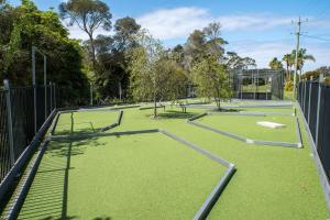 an empty tennis court with two tennis courts at Tasman Holiday Parks - Merimbula in Merimbula +81 photos