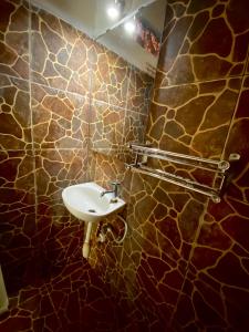 a bathroom with a sink and a stone wall at Salt Life Gili Trawangan in Gili Trawangan