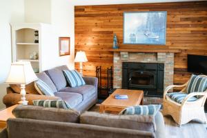 a living room with a couch and a fireplace at Beach Acres Resort in Parksville