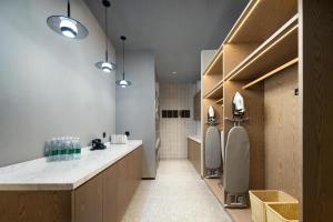 a bathroom with two urinals and a sink at Atour Hotel Shanghai Pudong Airport Zhunan Road in Nanhui +11 photos