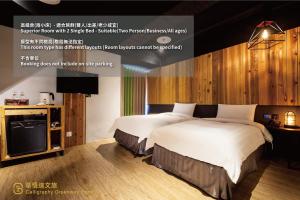 a bedroom with a large bed and a tv at Calligraphy Greenway Hotel in Taichung