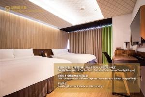 a poster of a hotel room with a bed and a desk at Calligraphy Greenway Hotel in Taichung