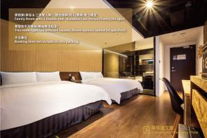 a hotel room with two beds and a kitchen at Calligraphy Greenway Hotel in Taichung