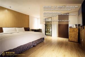 a hotel room with a bed and a sign on the wall at Calligraphy Greenway Hotel in Taichung