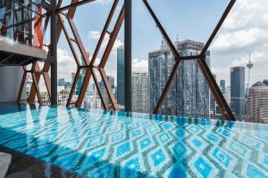 a swimming pool on the top of a building at Scarletz KLCC Apartments by soulasia in Kuala Lumpur