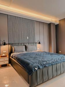 1 dormitorio con 1 cama grande con manta azul en Clark CU Hotel, en Ángeles