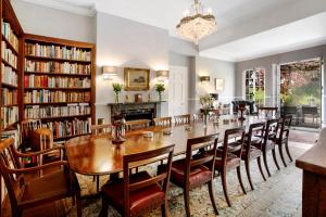 a dining room with a long table and chairs at Colleton Hall in Rackenford