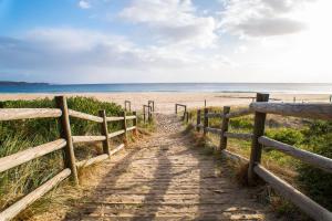 a path to the beach with a fence at BIG4 Tasman Holiday Parks - Tathra Beach in Tathra