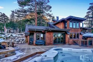 a house with a hot tub on a deck at Bronson by AvantStay Luxurious Home On The Slopes in Olympic Valley