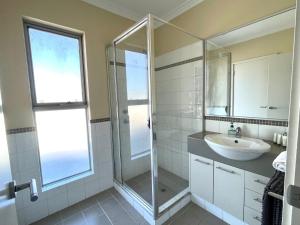 a bathroom with a sink and a glass shower at Getaway, Unit 20 Seafront Estate in Jurien Bay +12 photos