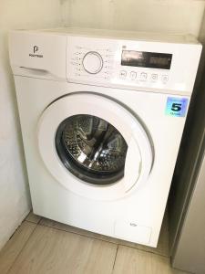a white washing machine sitting in a room at Little Bear Bungalows in Gili Air