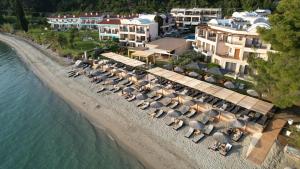 an aerial view of a beach with umbrellas at Olympion Sunset Halkidiki in Fourka