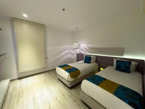 Cama ou camas em um quarto em Hotel Catedral Plaza