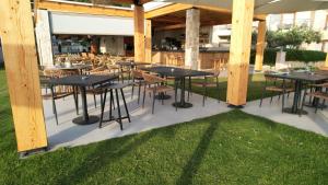 a group of tables and chairs under a pavilion at Olympion Sunset Halkidiki in Fourka