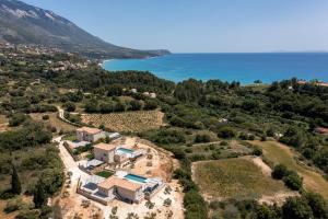 an aerial view of a house on a hill next to the ocean at Kefalonia Stone Villas - Villa Petros Kefalonica in Trapezaki