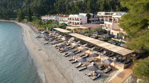 an aerial view of a beach with chairs and umbrellas at Olympion Sunset Halkidiki in Fourka