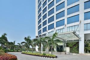 a building with palm trees in front of it at The Westin Kolkata Rajarhat in Kolkata