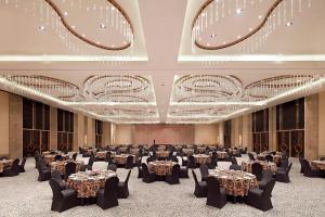 a banquet hall with tables and chairs in a room at The Westin Kolkata Rajarhat in Kolkata +75 photos