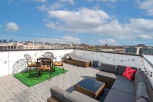 a patio with a couch and a table on a roof at Luxury Townhome Skyline Views Mins To DT in Nashville