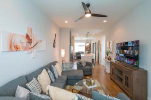 a living room with a couch and a tv at Luxury Townhome Skyline Views Mins To DT in Nashville