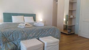 a bedroom with a blue bed with two stools at Emerald Blue in Skiathos