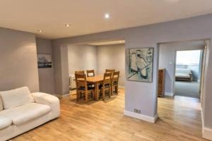 a living room with a white couch and a table at Charming Apartment in Deal near the Beach & Town in Kent +6 photos