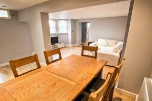 a living room with a wooden table and a couch at Charming Apartment in Deal near the Beach & Town in Kent