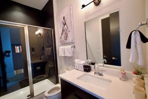 a bathroom with a sink and a toilet and a shower at Luxury Townhome Skyline Views Mins To DT in Nashville