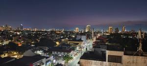 a view of a city at night with buildings at Voss Condominium in Manila