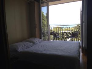 um quarto com uma cama e uma grande janela em Apartment Jadranka em Portorož