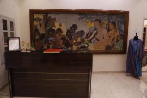 a painting of a group of people on a wall at HERITAGE HAVELI VARANASI in Varanasi