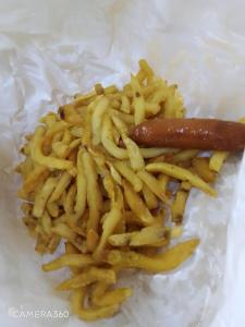 a pile of french fries and a hot dog at Backpackers at Banana Hill in Nairobi