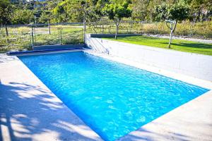 a swimming pool with blue water in a backyard at Villa Carpenter in Trebinje