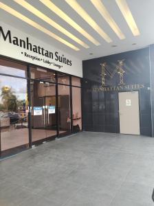 een gebouw met een bord dat Manhattan Suites leest bij Thirteen Residence [TR06] @ ITCC Manhattan Suites in Kota Kinabalu
