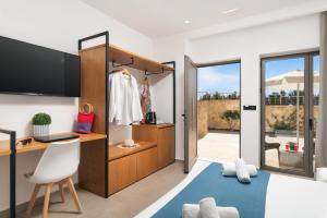 a room with a closet with a desk and a chair at Diamond Star Hotel in Falasarna