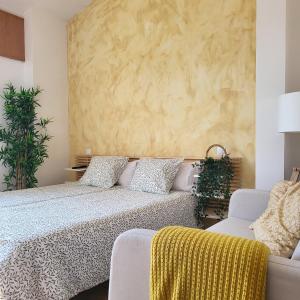 a bedroom with a large bed and a couch at Hotel Rural Luna Llena in Torremocha de Jarama