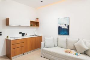 a living room with a couch and a kitchen at Diamond Star Hotel in Falasarna