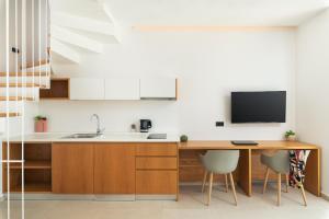 a kitchen with a desk and a tv on the wall at Diamond Star Hotel in Falasarna