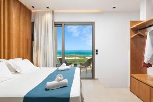a bedroom with a bed and a view of the ocean at Diamond Star Hotel in Falasarna