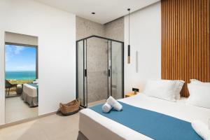 a bedroom with a bed and a glass shower at Diamond Star Hotel in Falasarna