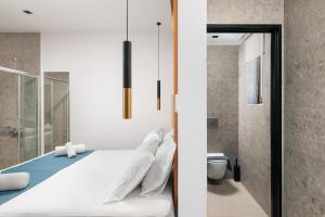 a bedroom with a white bed and a shower at Diamond Star Hotel in Falasarna