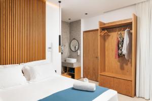 a bedroom with a bed and a bathroom with a sink at Diamond Star Hotel in Falasarna