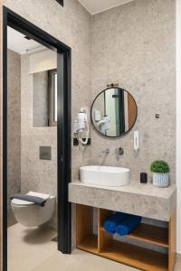 a bathroom with a sink and a mirror at Diamond Star Hotel in Falasarna