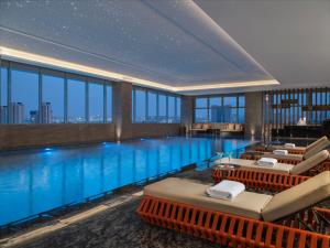 a hotel swimming pool with a view of the city at Holiday Inn Shijiazhuang High-tech Zone, an IHG Hotel in Shijiazhuang