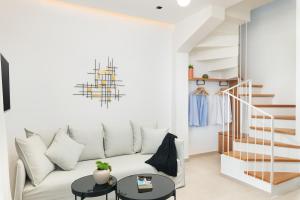 a living room with a white couch and a table at Diamond Star Hotel in Falasarna