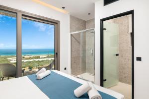 a bedroom with a bed and a view of the ocean at Diamond Star Hotel in Falasarna